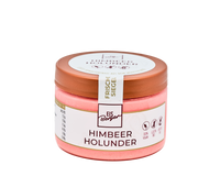 Ein rosa Glas Hofmanns Shop Premium-Eis Himbeere-Holunder mit veganen Sorbet-Symbolen und Kupferdeckel.