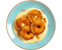 Vier Hofmanns Shop Apfelringe auf Quark-Vanillesoße mit Zimt, serviert auf einem blauen Teller.