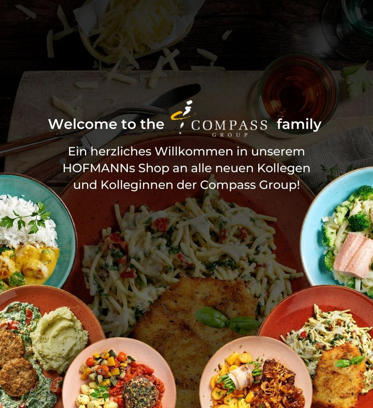 Willkommensnachricht von Compass Group mit einer Auswahl farbenfroher Gerichte, die auf einem Tisch präsentiert werden.
