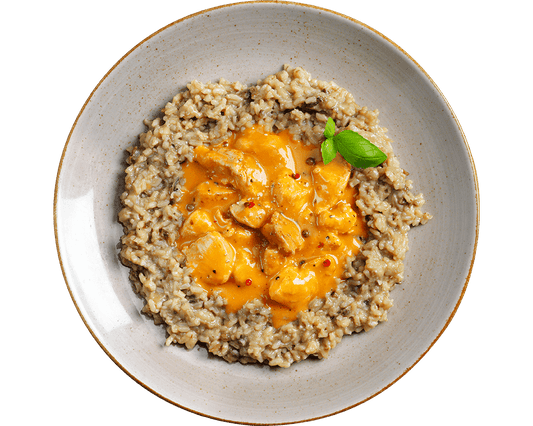 Cremiges Steinpilzrisotto mit Hofmanns Shop Hähnchentaler „4-Pfeffer“, garniert mit frischem Basilikum.