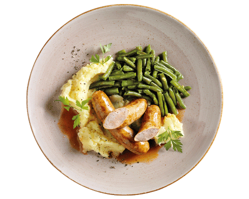 Hofmanns Shop Hausmacher Bratwurst mit Bratensoße, Kartoffelpüree und grünen Bohnen – frisch serviert.