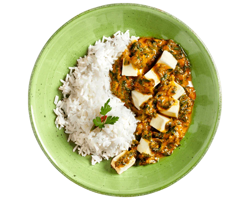 HOFMANNs Palak Paneer mit Basmati-Reis, garniert mit Koriander auf einem grünen Teller.