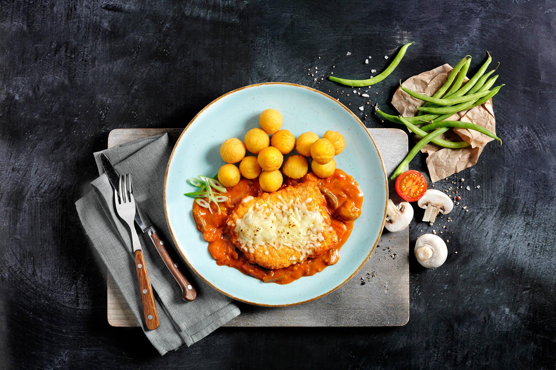 Klassiker aus aller Welt von HOFMANNs: Hähnchen in Sauce, Käse, Kartoffeln, grüne Bohnen und Gemüse.